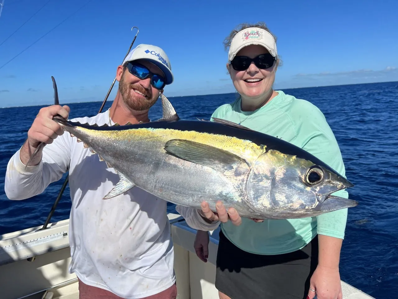 First Mate John with a trophy blackfin tuna caught live bait fishing on a shipwreck — DirtyBoat Charters Islamorada