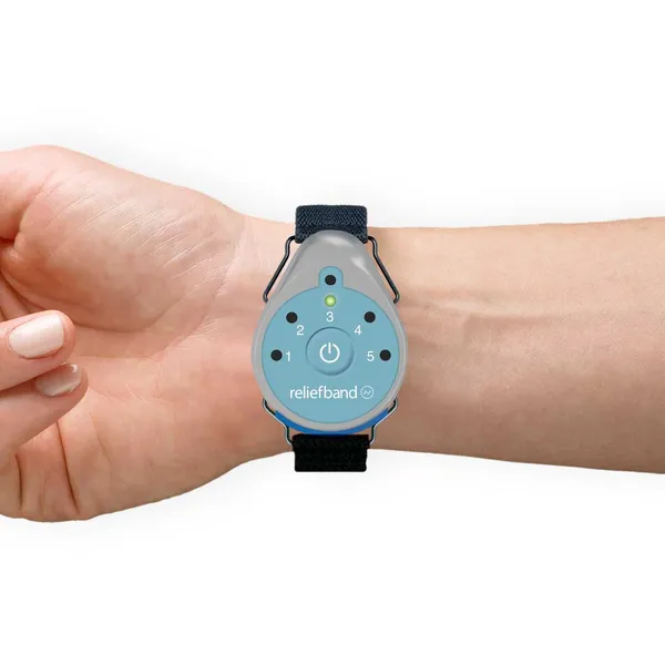 Reliefband Classic wristband worn on a person's wrist, showing the control buttons and FDA-cleared neuromodulation device