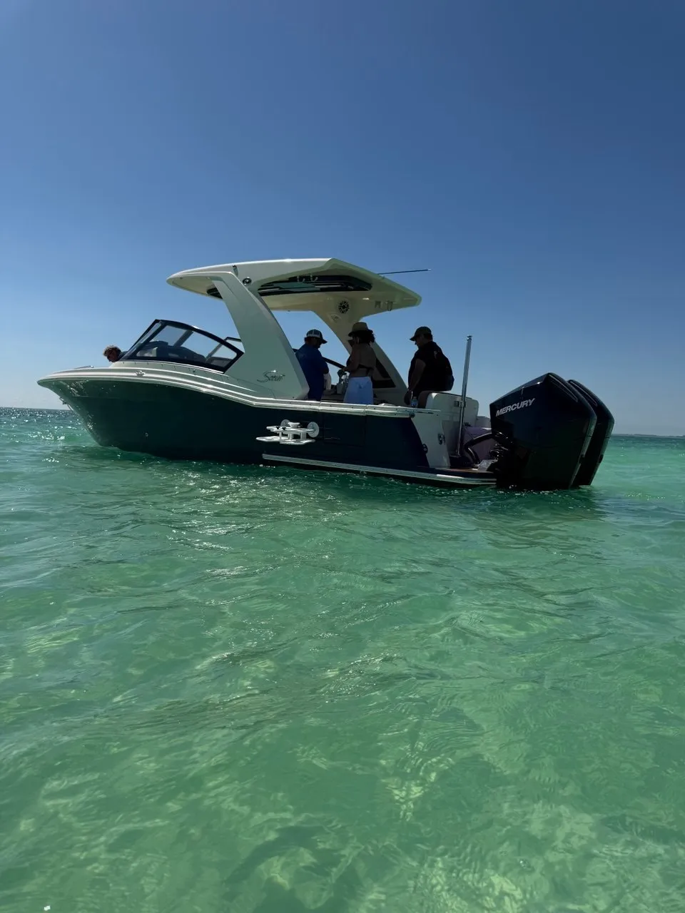 The Bougie Girl from stern angle at sandbar — crystal clear Florida Keys water