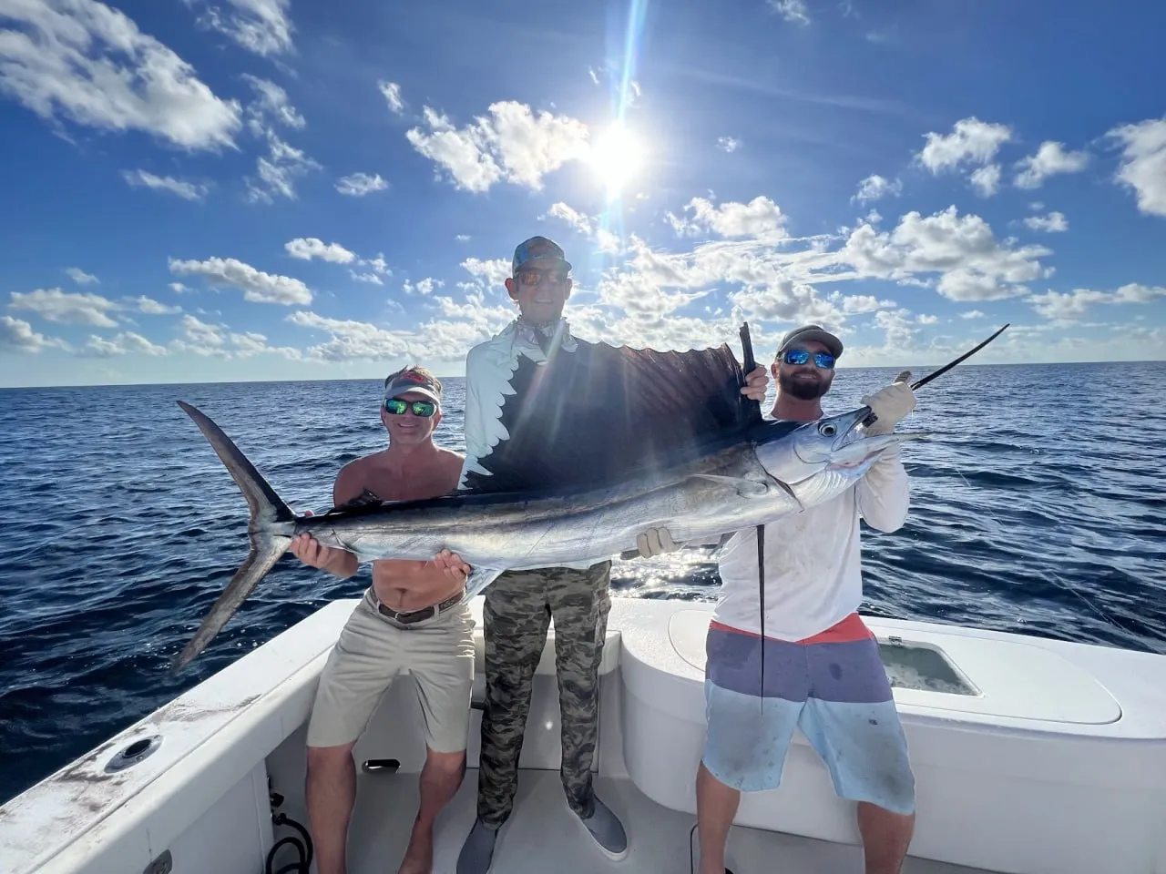 Lance, Todd and First Mate John holding a sailfish on the Atlantic — DirtyBoat Charters Islamorada