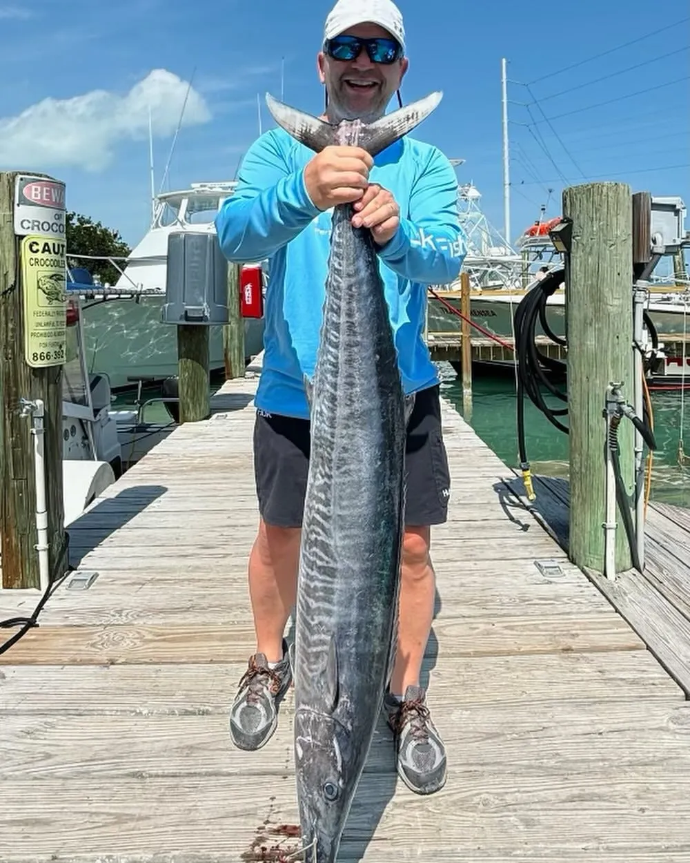 Patrick with his trophy wahoo on the dock at Robbie's Marina before mounting - DirtyBoat Charters