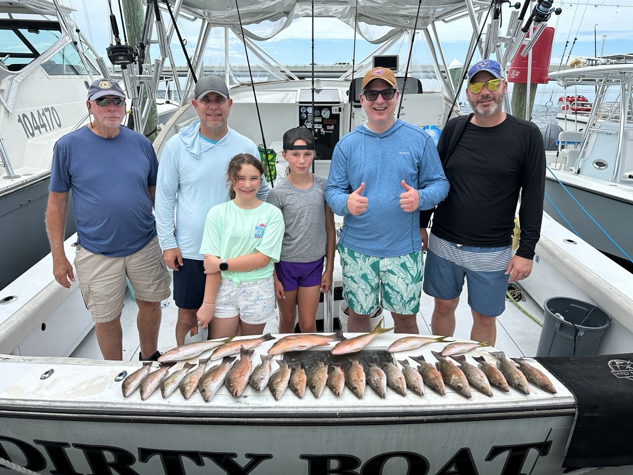 The DirtyBoat crew and the day's mangrove haul on the dock
