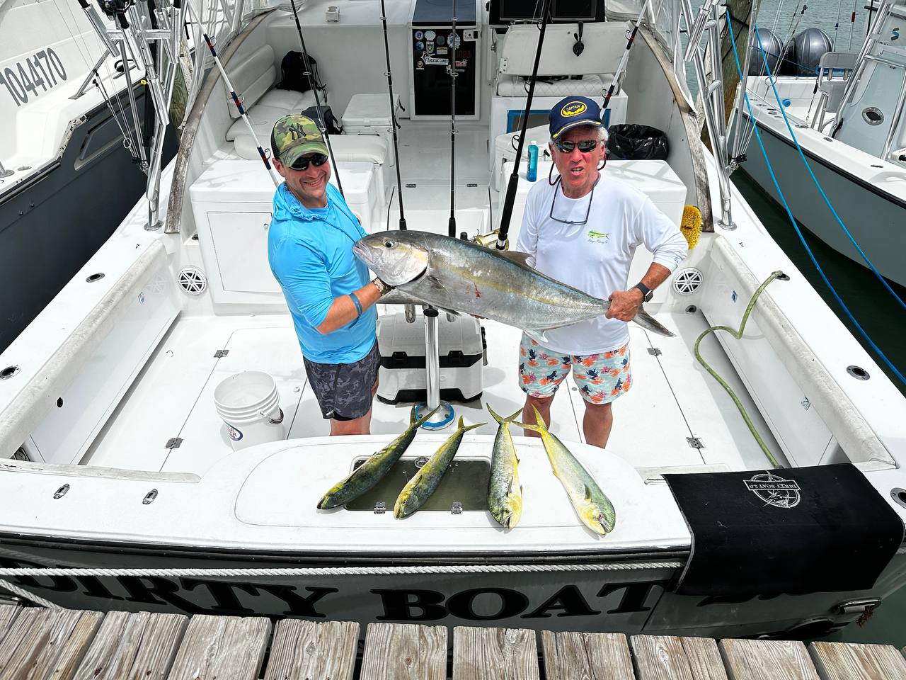 Harvey and Jason holding a big amberjack with four keeper mahi on the Dirty Boat