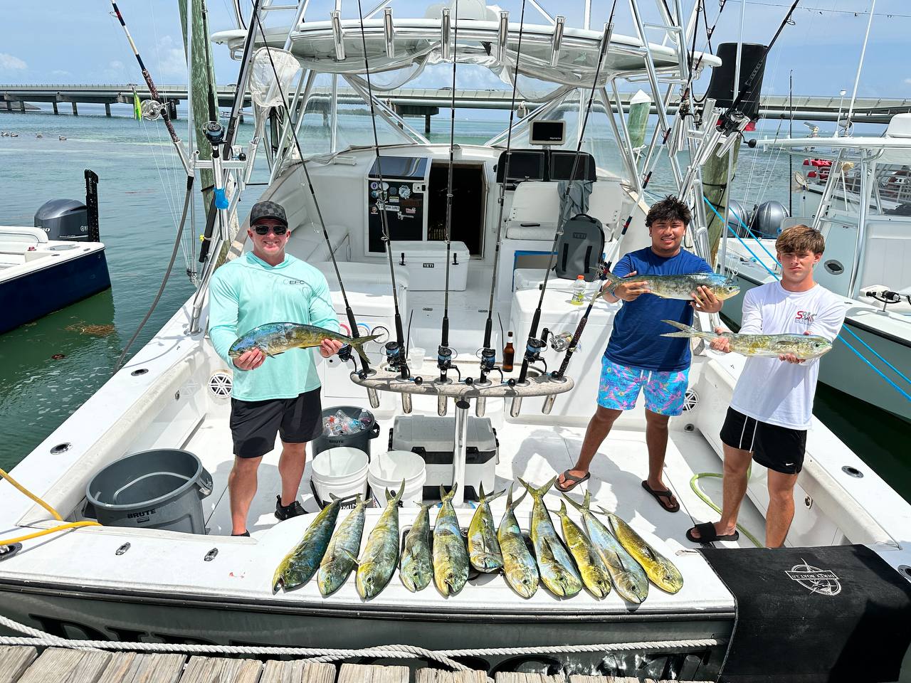 Jack, Jack, and Darren with 14 keeper mahi back at the dock on DirtyBoat