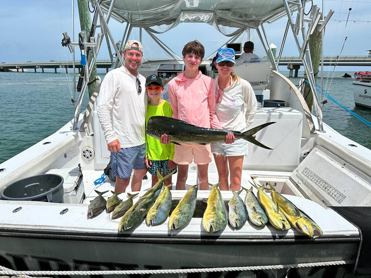 Chris, Jamie, Bronson, Brock, and Grandma Dawn with the day's mahi on DirtyBoat